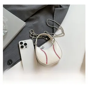 Close-up of white crescent handbag with red baseball stitching and silver bead chain