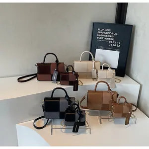 Detail view of retro color-block handbags in various sizes and earth tone colors