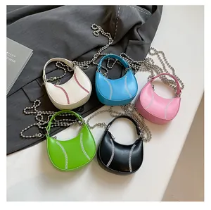 Detailed macro view of five colorful baseball-shaped mini crossbody bags with bead chains