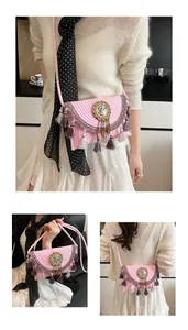 Pink bohemian woven crossbody bag with colorful bead accents and long flowing tassels