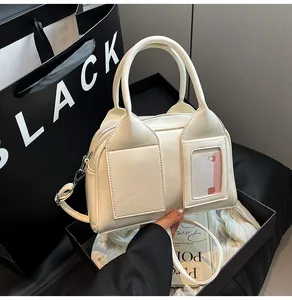 Close-up of cream shoulder bag with dual pockets and transparent bunny card slot