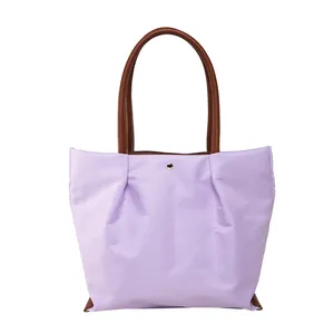 Light purple waterproof nylon tote bag with brown PU leather handles and gold button