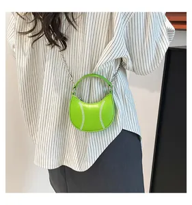 Detail of neon green mini ball bag with white stitching and silver chain strap