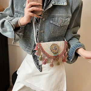 Bohemian woven crossbody bag with colorful embroidery and tassels for beach vacation