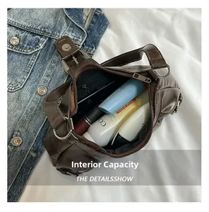Brown PU leather bag showing internal capacity with cosmetics and silver metal buckles