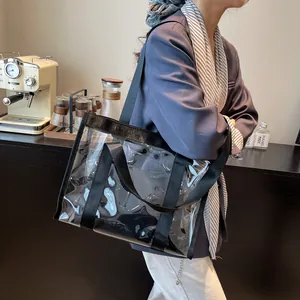 Transparent PVC beach tote with black nylon straps shown on shoulder for large capacity use