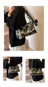 Detailed embroidery of golden cranes and clouds on black silk bag with wooden beads
