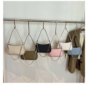 Detail view of woven leather shoulder bags in six colors with elegant chain straps