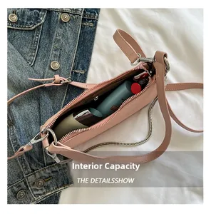 Internal capacity of pink pebbled leather underarm bag with metal chain detail