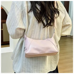 Detail of light pink PU leather bag with wide shoulder strap and silver zipper