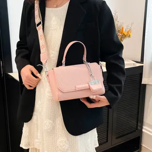 Pink PU leather handbag with woven texture and ethnic style embroidered strap