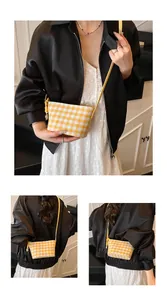 Detail of yellow and white checkered tote bag featuring a decorative side knot design