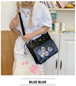 Detail of black ita bag with transparent PVC window showing plush bear and anime pins