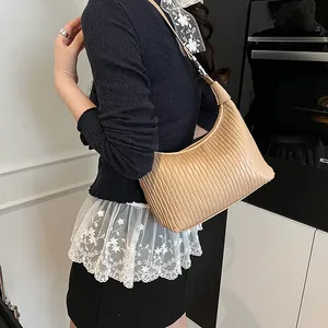 Borsa a spalla beige a mezzaluna con pieghe verticali e texture a fisarmonica