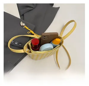 Interior view showing the storage capacity of a yellow plaid tote bag with a zipper pocket