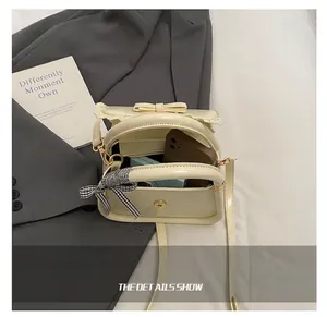 Internal capacity of the cream crossbody bag showing space for phone and makeup