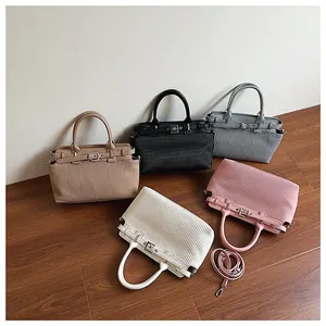 Detailed overhead view of pleated handbags in five colors with metal buckle accents