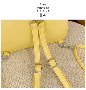 Close-up of adjustable shoulder strap with silver hardware and yellow PU leather stitching