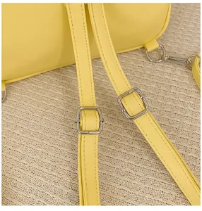 Close-up of adjustable shoulder strap with silver hardware and yellow PU leather stitching