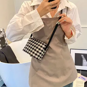Classic black and white gingham crossbody tote bag with adjustable black shoulder strap