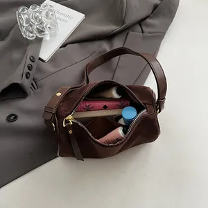 Brown matte cylinder barrel bag shown with interior storage space for daily essentials