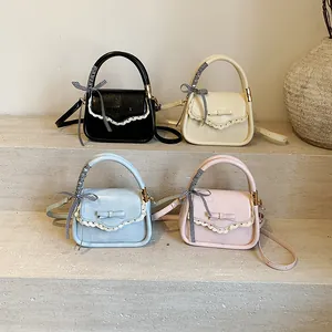 Women's mini crossbody handbag with lace trim and bow details in four trendy colors