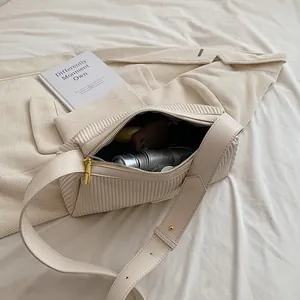 Borsa a cuscino plissettata color crema con ampia tracolla in pelle alla moda