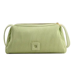 Borsa a cuscino verde menta minimalista con trama plissettata verticale e tracolla in pelle
