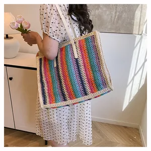 Detail of colorful rainbow woven straw tote bag with premium cream leather long handles