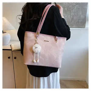 Pale pink faux suede tote bag featuring long-legged plush charm in modern interior