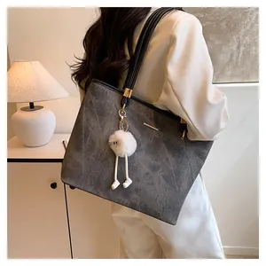 Grey textured large capacity tote bag with black straps and white plush pendant detail