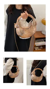 Detail of rose gold metal handbag featuring pleated texture and round integrated handle