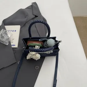 Retro navy tote bag with woven handles showing internal capacity for daily commuting