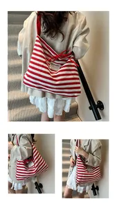 Detail of red and white striped canvas tote bag showing the textured fabric and logo patch