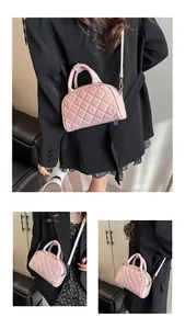 Detail showing the pink quilted Boston bag with silver hardware and adjustable strap
