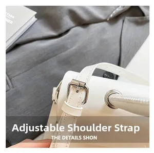 Macro detail of adjustable white shoulder strap with silver metal buckle on bag