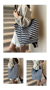 Detail of a large striped canvas tote bag featuring premium texture and vintage label