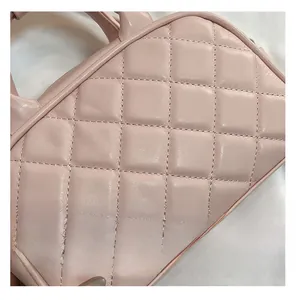 Close-up of quilted light pink Boston bag showing premium leather stitching and texture
