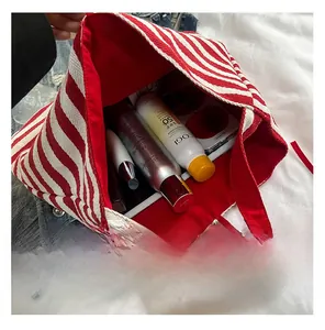 Interior view of striped canvas tote showing spacious capacity with personal items