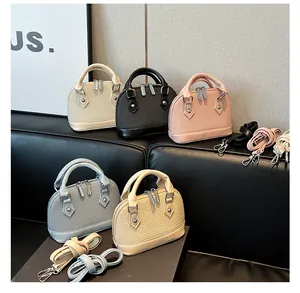 Detail of five woven leather shell bags in pastel colors with crossbody straps