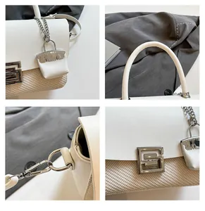 Detail view of woven fabric and leather mix shoulder bag with metallic G-shaped hardware