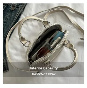 Top view of beige shell bag showing internal capacity for phone and cosmetics