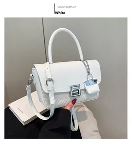 Detail of white leather shoulder bag with woven base and silver square S-lock buckle