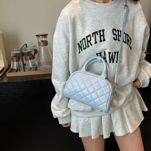 Light blue quilted mini Boston bag with classic rhombus stitching and top handles