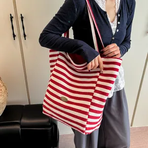 Red and white striped canvas tote bag with large capacity shown in a lifestyle setting