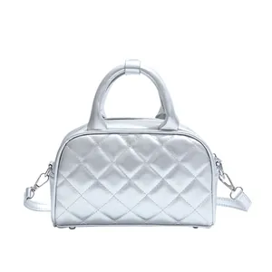 Chic silver quilted Boston bag with crossbody strap and metallic faux leather finish