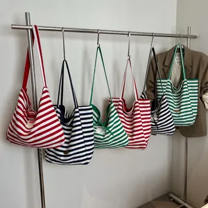 Chic oversized striped canvas tote bags with leather straps and interior brand labels
