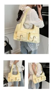 Detailed close-up of glossy pale yellow PU leather handbag with silver metal buckles
