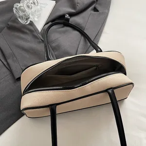 Canvas bowling briefcase with black leather trim and spacious interior with zipper pocket