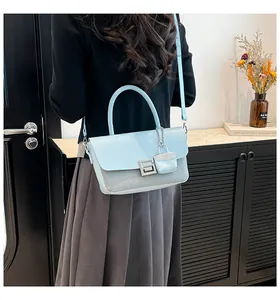 Detail of light blue crossbody bag featuring woven texture and a decorative mini charm